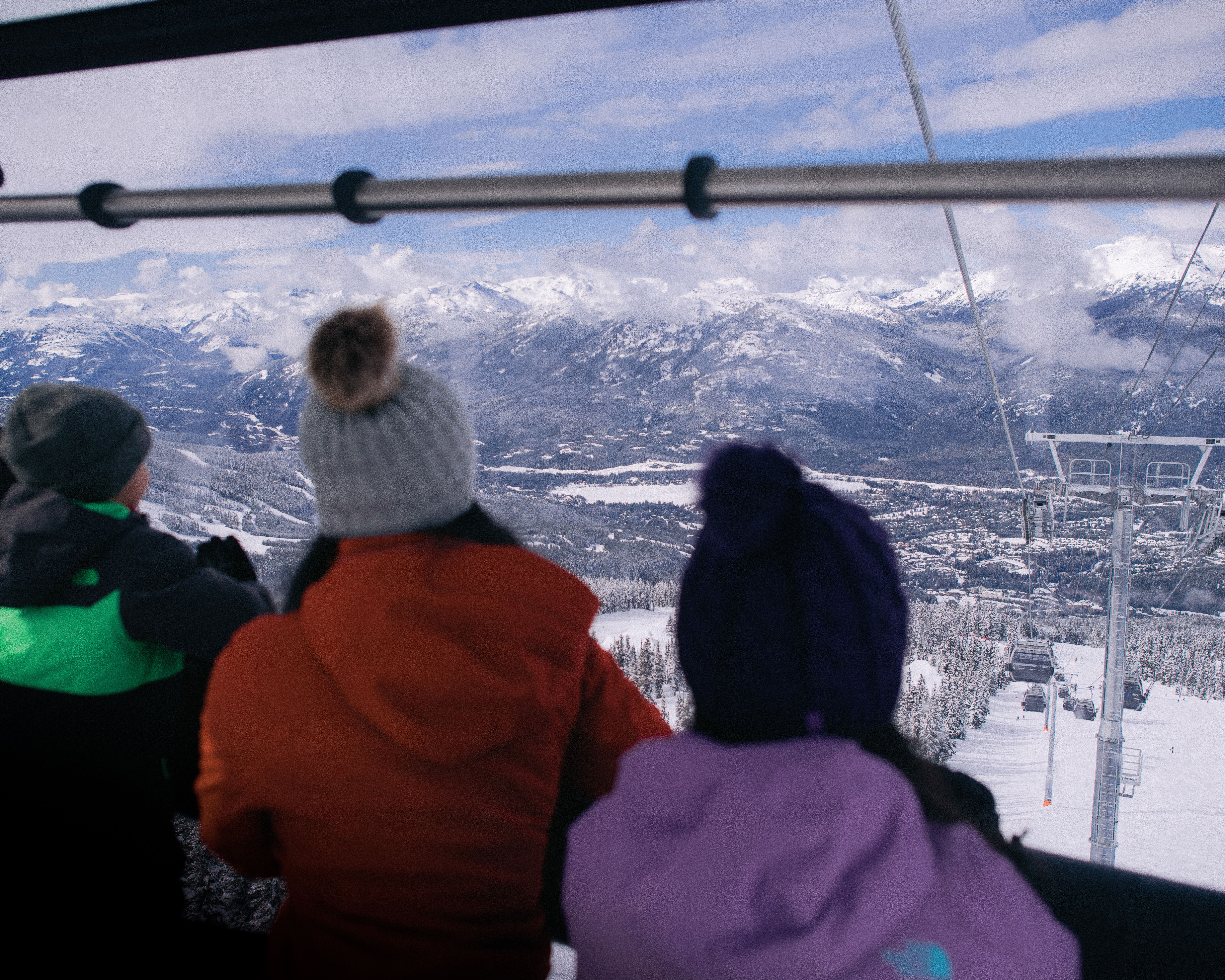 Whistler Skiing Vacations: A young family looking at the view from Blackcomb Gondola.