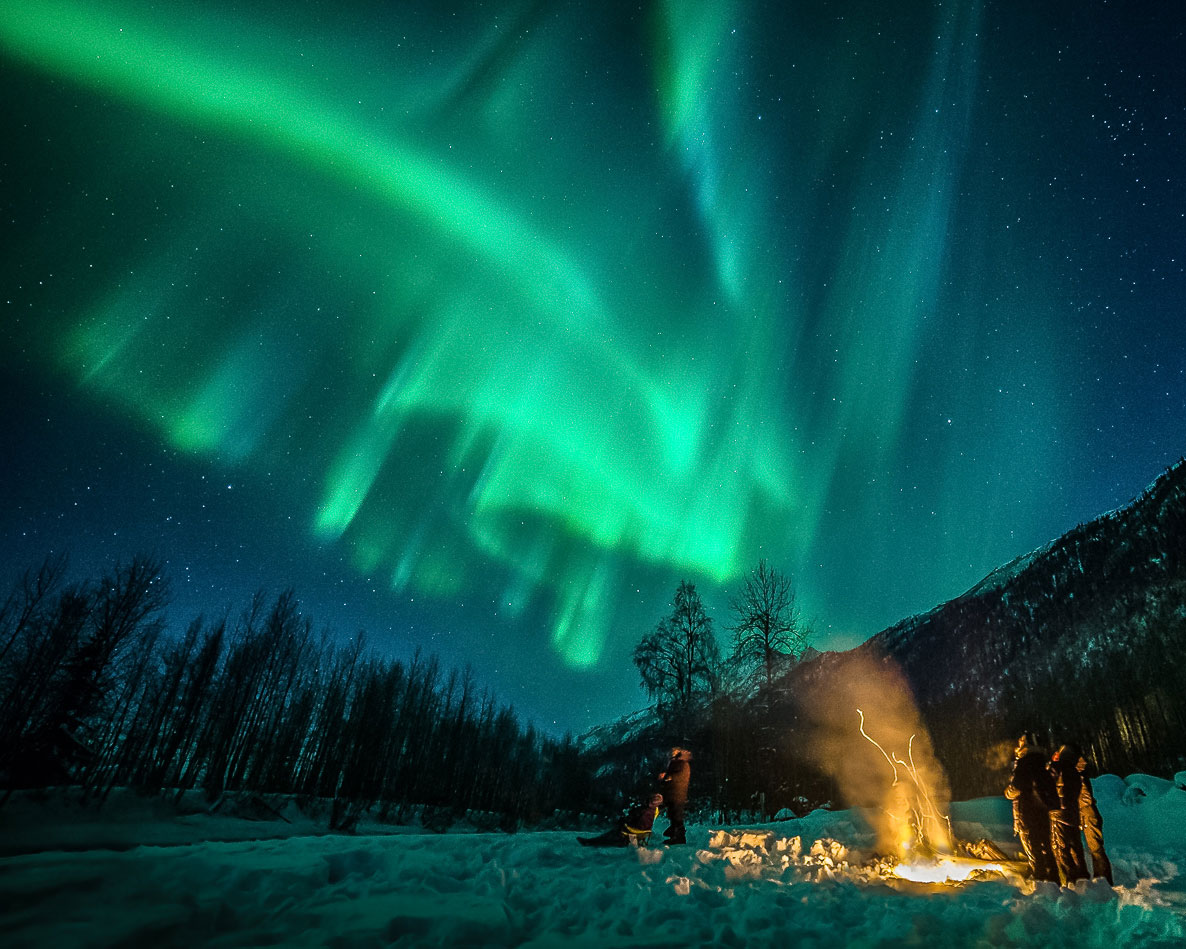When watching the Northern Lights in Alaska we recommend building a fire for toasty aurora-watching bliss! Credit: Jody. O