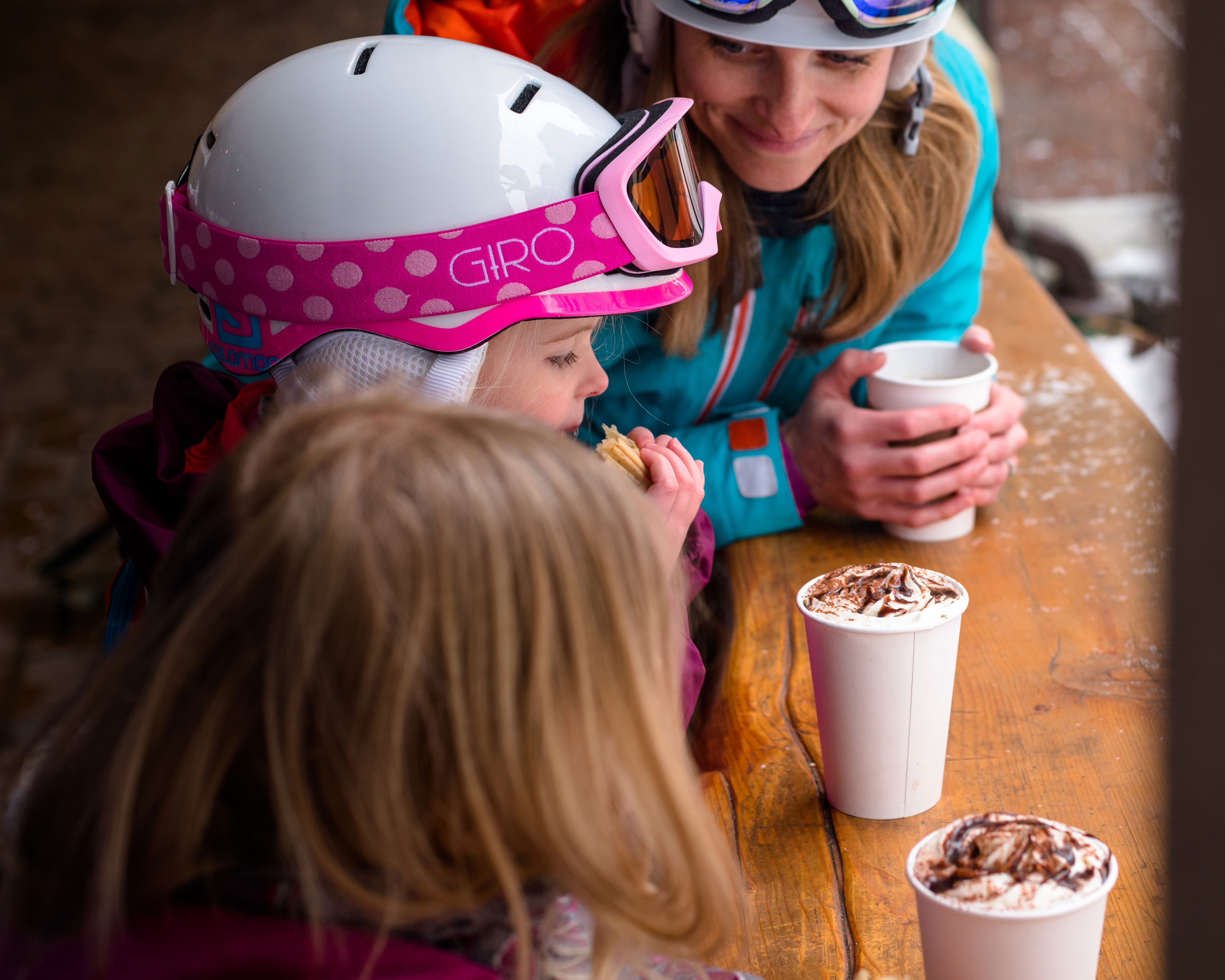 Whistler Skiing Vacations: Kids drinking hot chocolate in ski gear.