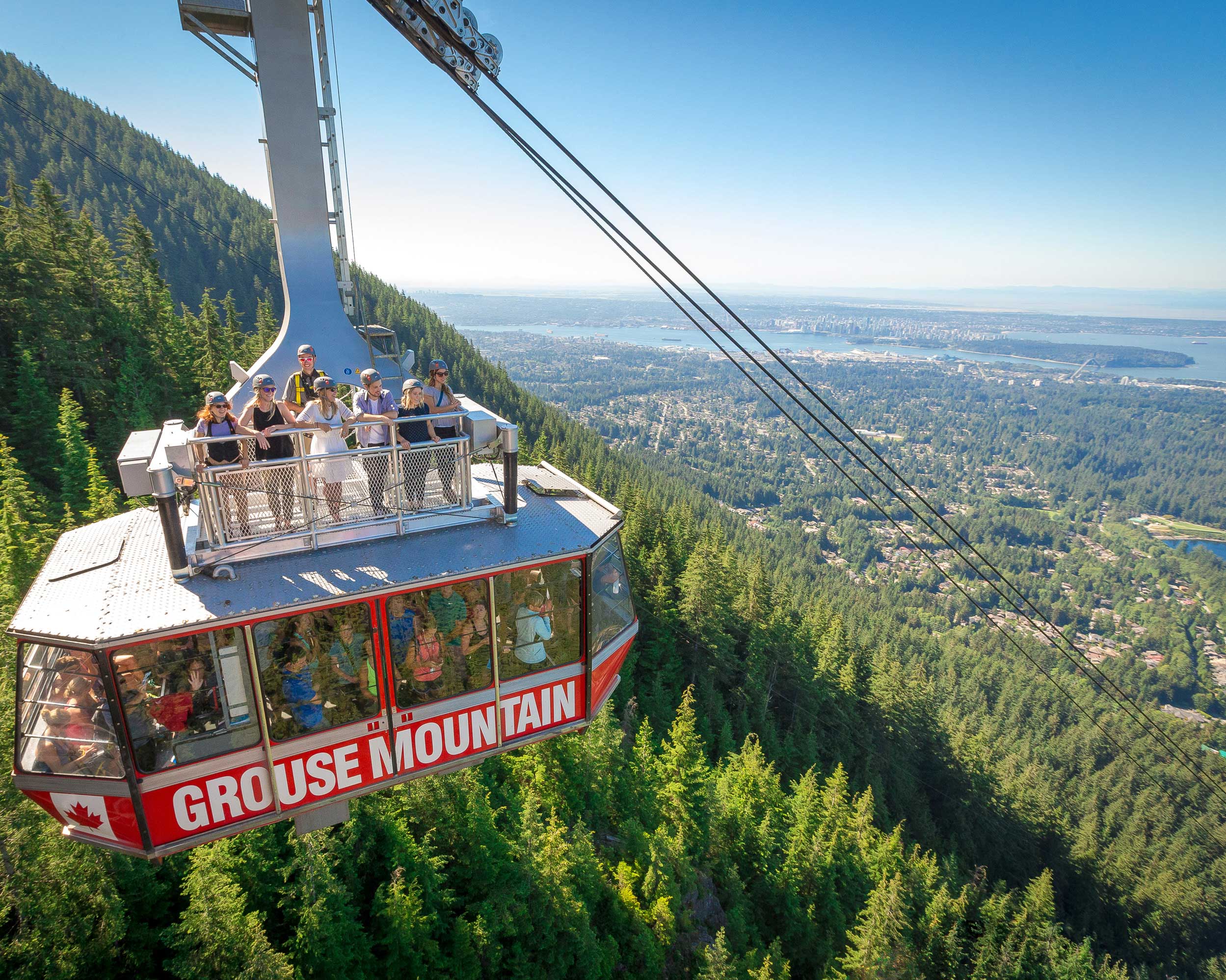 Vancouver vacations: Grouse Mountain gondola ascending above Vancouver.