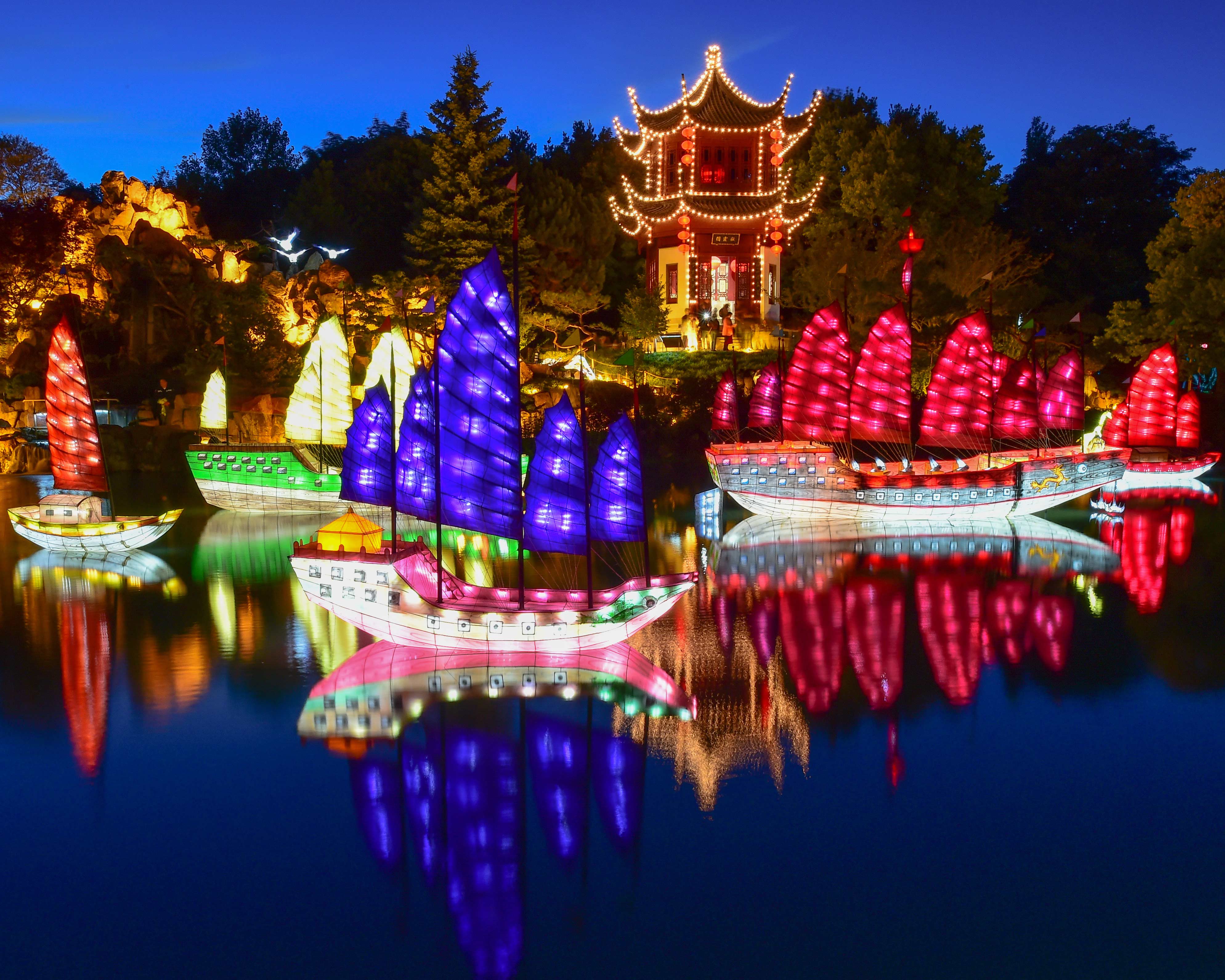 Montreal Travel Guide: lit up colored boats on a lake.