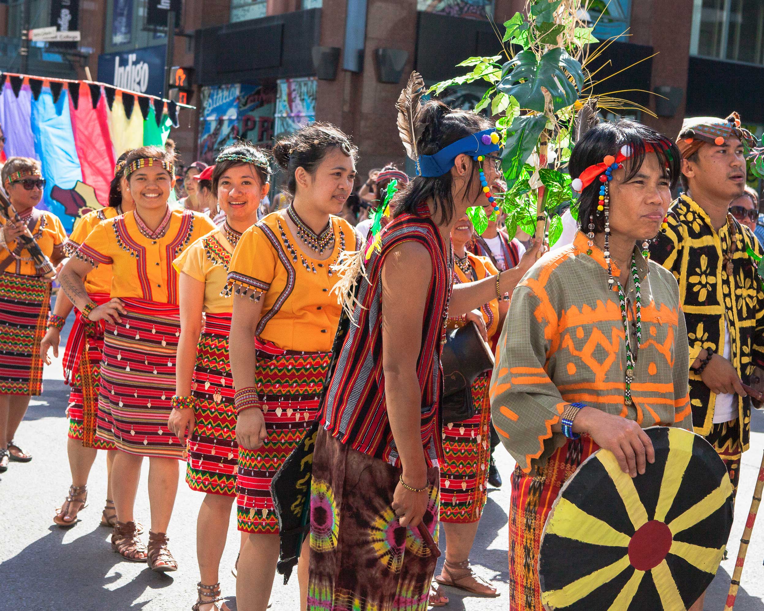 Montreal Travel Guide: parade of people in bright, First Nations clothing.