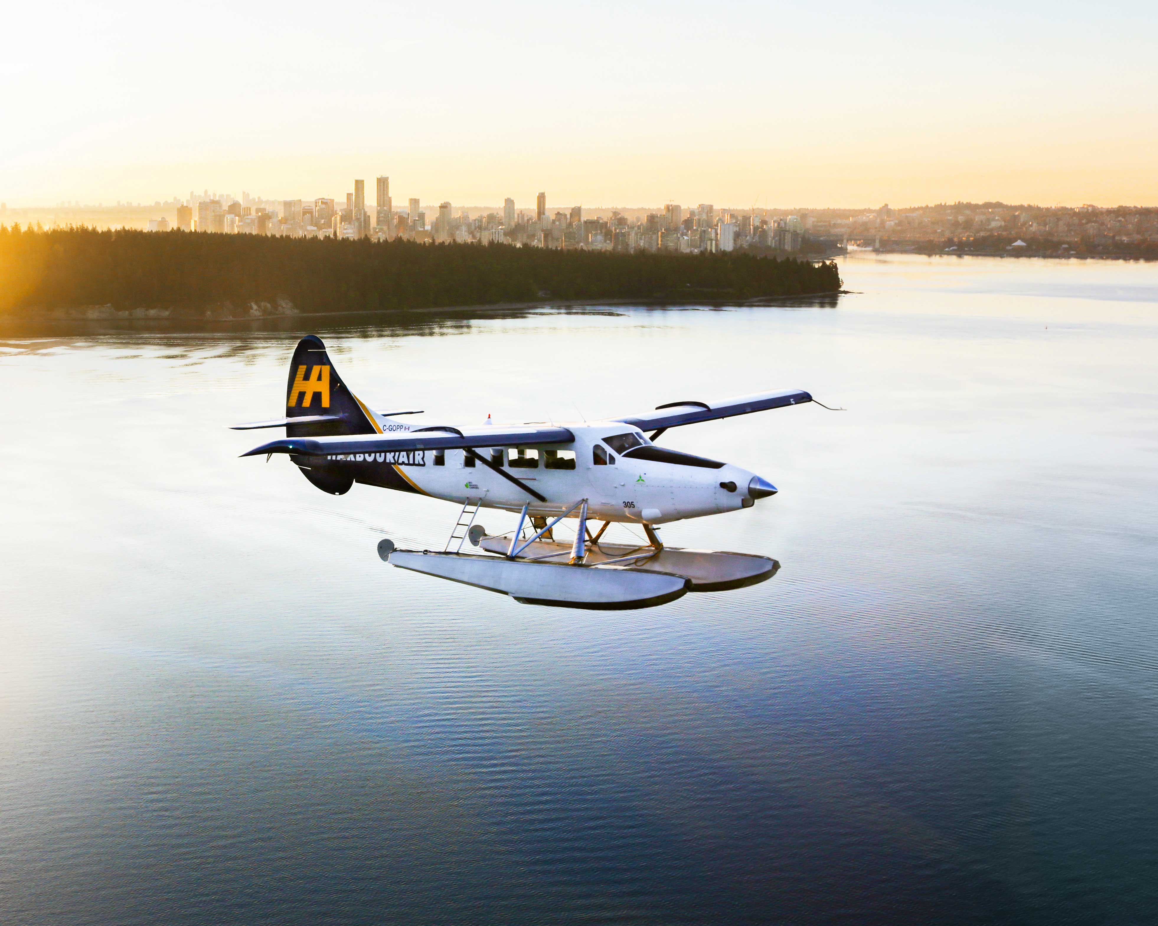Vancouver vacations: a seaplane soaring away from Vancouver at sundown.
