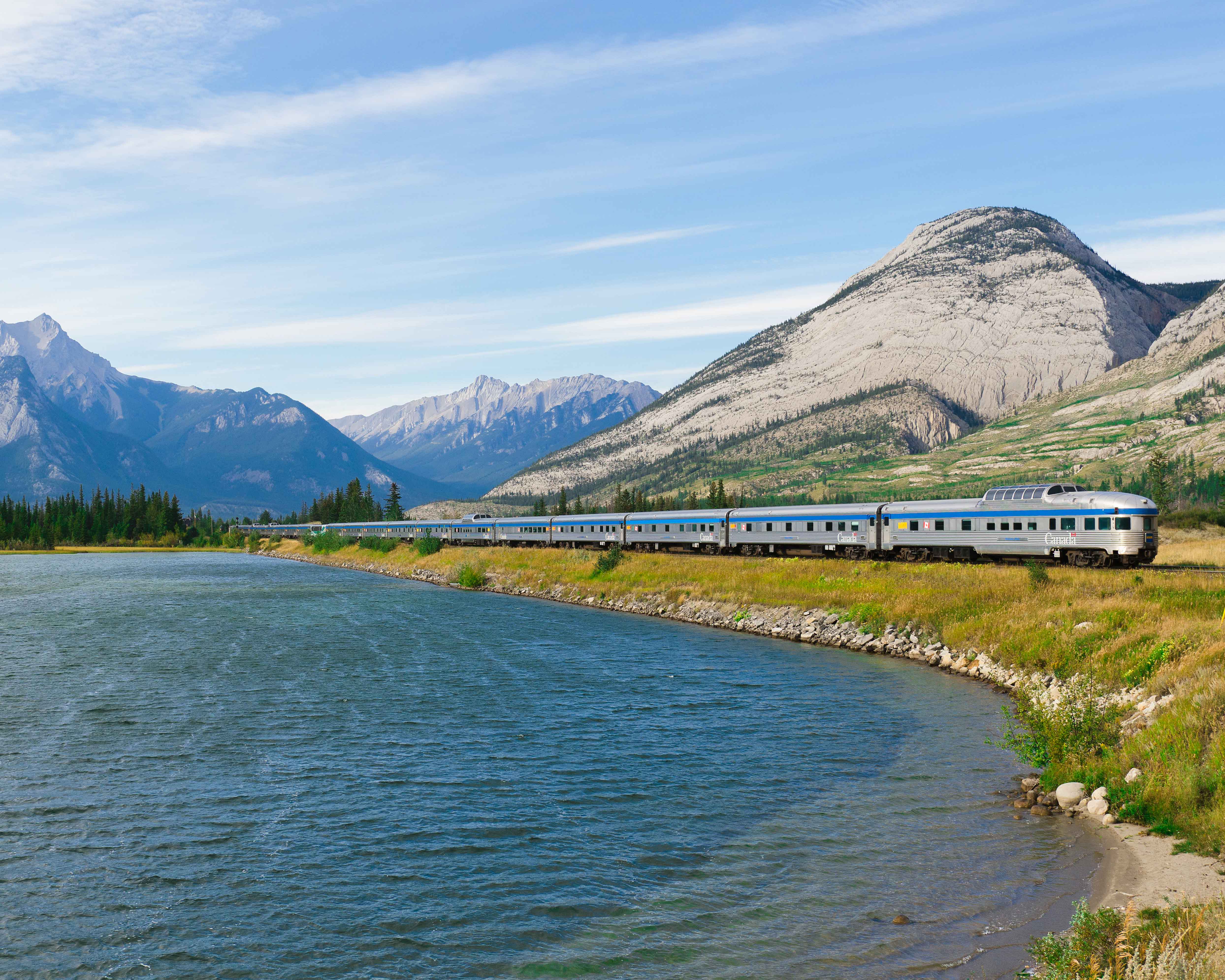High-end train travel: Train going past a lake in Canada.