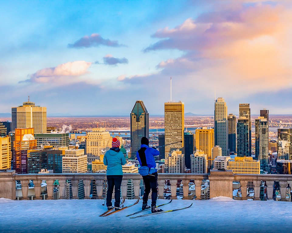 Montreal Travel Guide: cross-country skiers looking out over Montreal's skyline.
