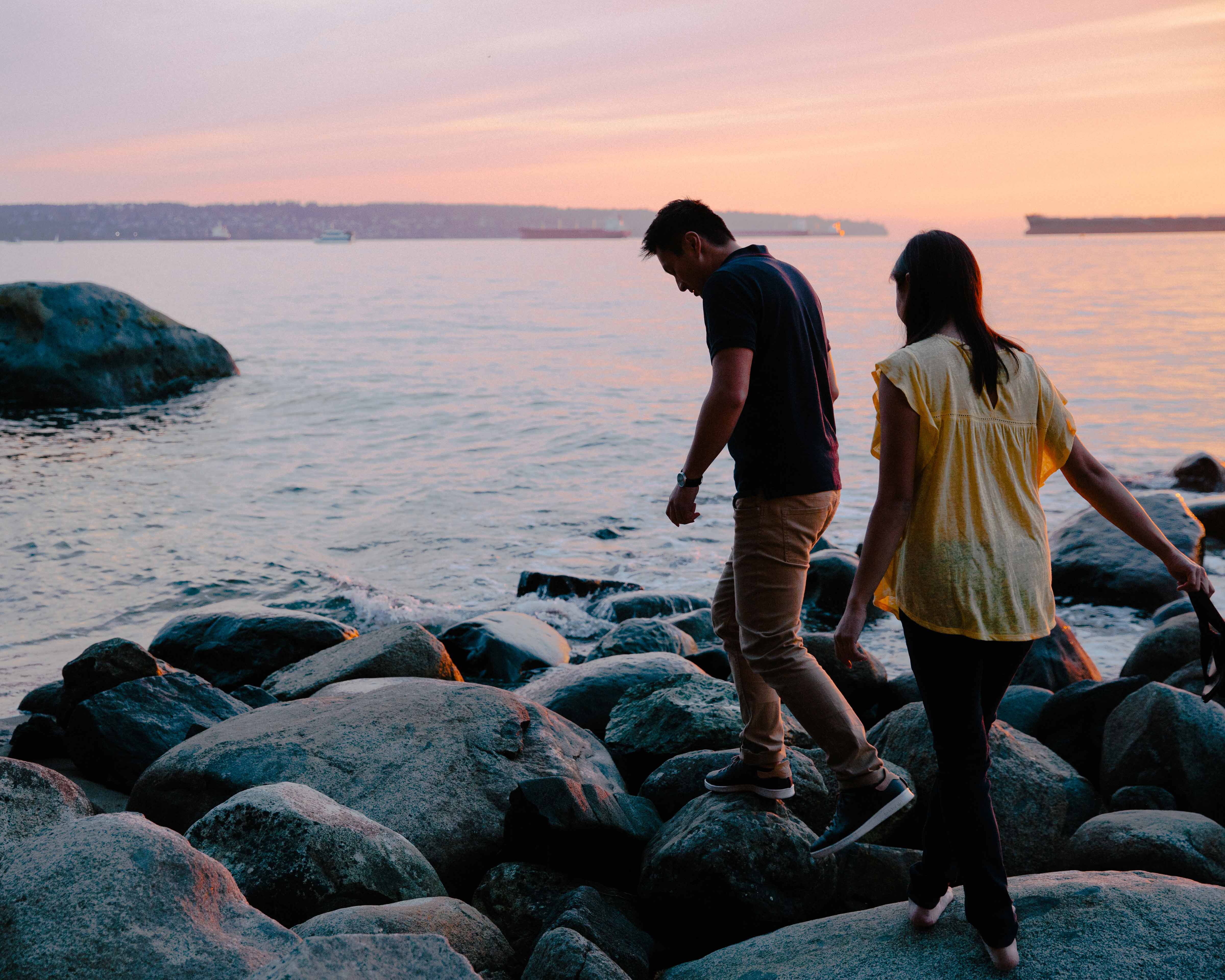 Honeymoon destinations in Canada: young couple at the beach at sunset.