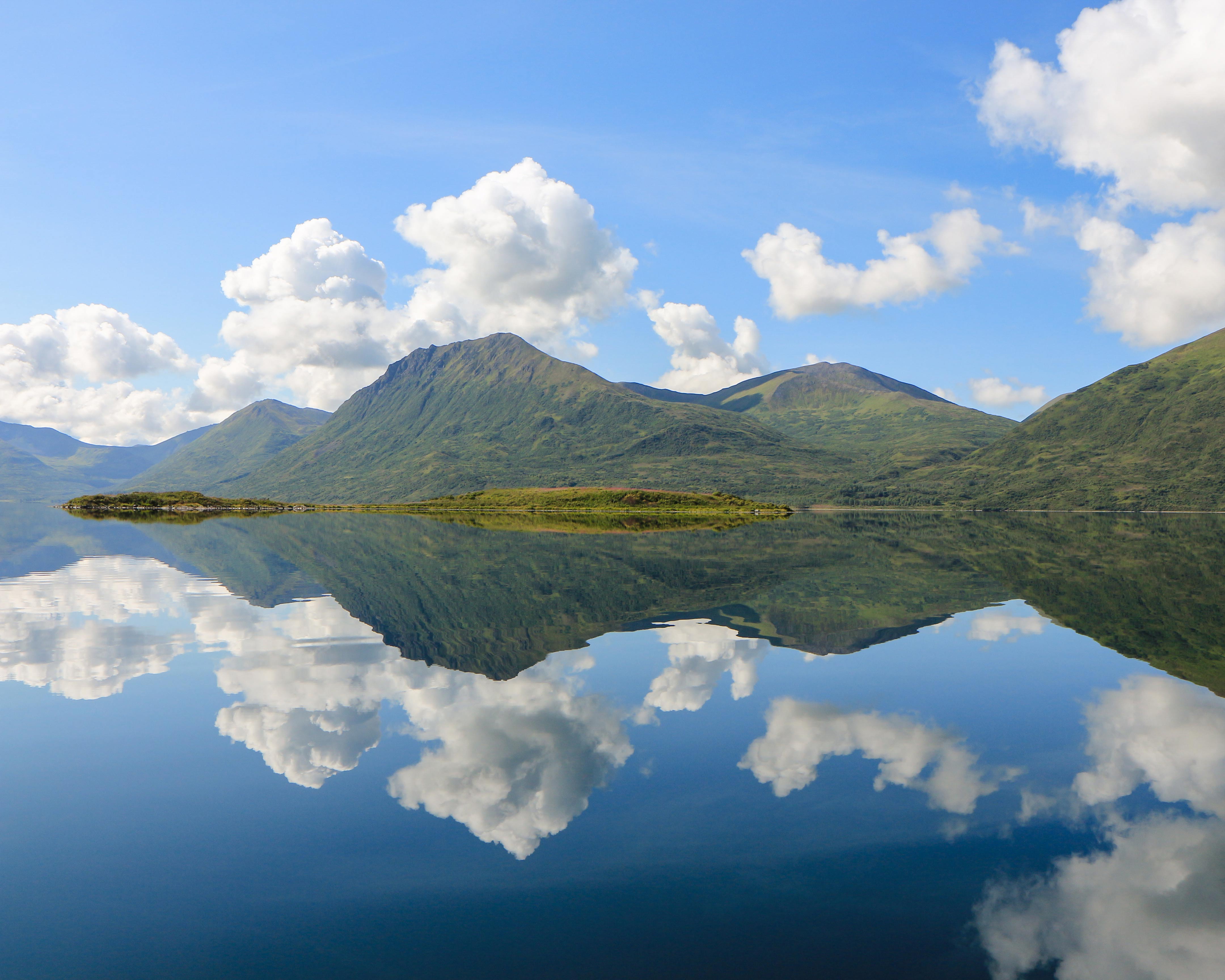 Bear watching on Kodiak Island: picturesque lake reflecting the mountains and blue sky.